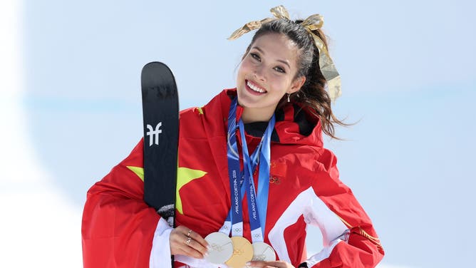 Gold medalist Eileen Gu Ailing of Team China celebrates with her three medals won in Slopestyle, Big Air and Halfpipe competitions during the medal ceremony for the Women's Freeski Halfpipe Final on day sixteen of the Milano Cortina 2026 Winter Olympics.