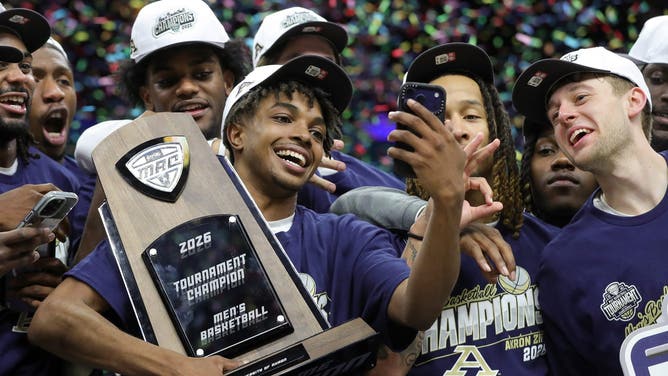 Akron guard Tavari Johnson celebrates with teammates after winning the Mid-American Conference championship at Rocket Arena, March 14, 2026, in Cleveland, Ohio.
