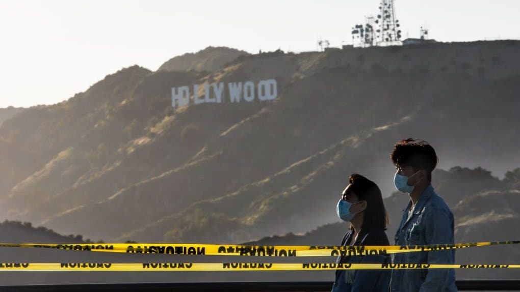Two people wearing masks in California