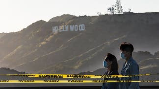 Two people wearing masks in California