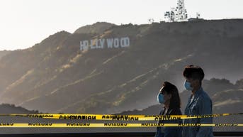 Two people wearing masks in California