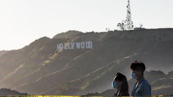 Two people wearing masks in California