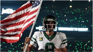 New York Jets quarterback Aaron Rodgers ran onto the field carrying a massive American flag on the anniversary of 9/11. (Credit: Getty Images)