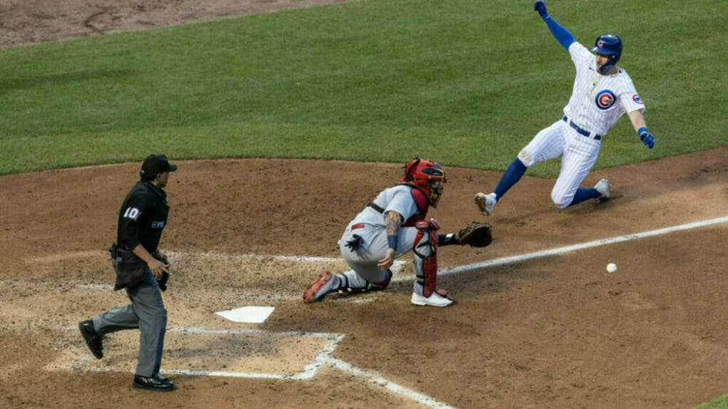 Yadier Molina #4 of the St. Louis Cardinals tags out Patrick Wisdom #16 of the Chicago Cubs during the game at Wrigley Field.