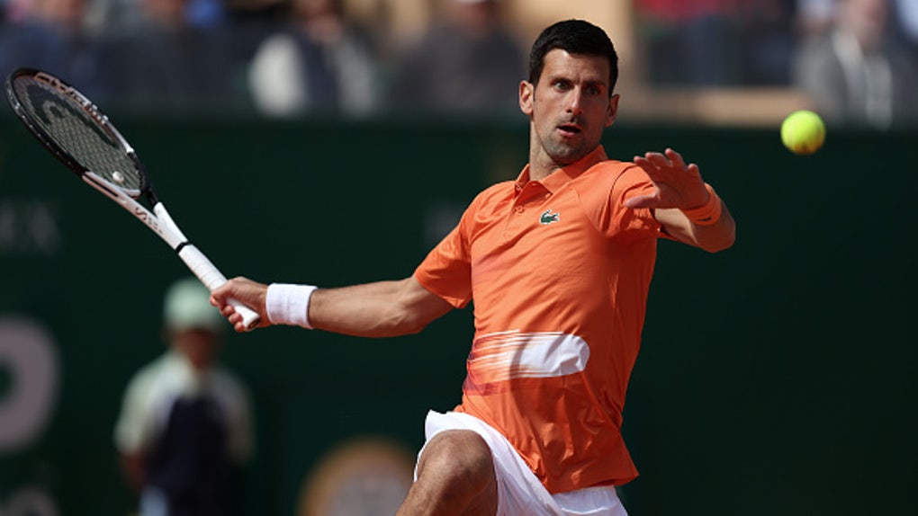 Novak Djokovic jumps to hit a forehand 