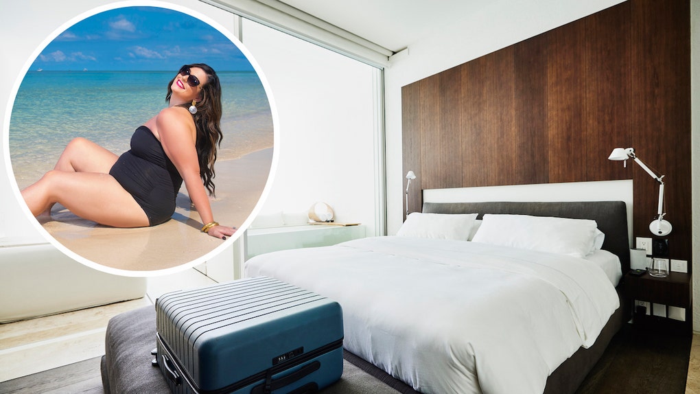 9c4a7024-Wide shot of suitcase at end of bed in luxury hotel room