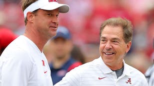Lane Kiffin and Nick Saban share a laugh before the Ole Miss vs. Alabama game