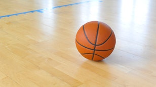 0bcd2167-Basketball ball over floor in the gym. Team sport.