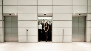 006ee9e2-Group of business people inside an office lift