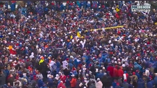 Kansas fans celebrate the win over Oklahoma by carrying to goal posts out of the stadium