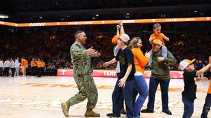 Navy Lieutenant Commander Zachary Smith surprises his family during the Tennessee basketball game on Saturday