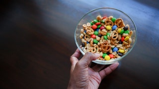 Woman Holds Bowl of Trail Mix