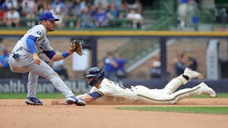 Mike Brosseau #20 of the Milwaukee Brewers beats a tag by Gavin Lux #9 of the Los Angeles Dodgers during the fifth inning to steal second base at American Family Field