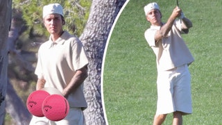 Justin Bieber walks around a swanky private golf course in Los Angeles with his pants down holding his private parts as heu2019s looking for somewhere to pee