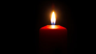 27cbe98e-The wax candle glows in the dark.