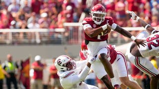 KJ Jefferson avoids a tackle by a Gamecock lineman
