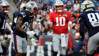New England Patriots quarterback Mac Jones huddles with his teammates