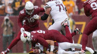 Cardinals defensive linemen Jalen Thompson sacks Washington Commanders QB Sam Howell at FedExField in Landover, Maryland.