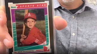 8a3960ac-Man holding Zuckerberg card