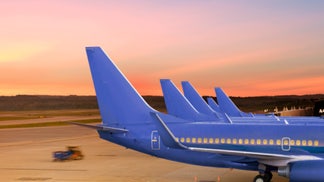 97c1c7e6-Passenger Jet Airplanes Docked at Airport Terminal