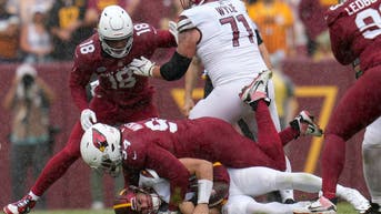 Cardinals defensive linemen Jalen Thompson sacks Washington Commanders QB Sam Howell at FedExField in Landover, Maryland.