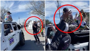 UFC fighter Dustin Poirier smacks man holding a sign disrespecting his wife. (Credit: Screenshot/Twitter Video https://twitter.com/TheArtOfWar6/status/1628040279176388608)