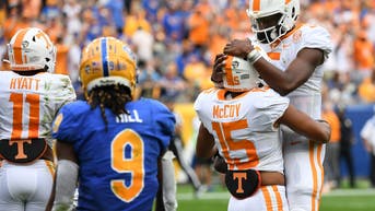 Bru McCoy celebrates with Hendon Hooker after scoring during the game against Pitt