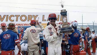 Richard Petty hoists the Firecracker 400 trophy