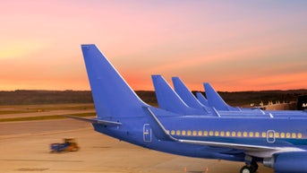 97c1c7e6-Passenger Jet Airplanes Docked at Airport Terminal