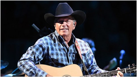 George Strait fans refused to be silenced by terrible weather conditions during a weekend concert in Nashville. They sang with gusto. (Credit: Getty Images)