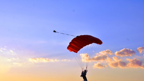 Parachutist inevening sky
