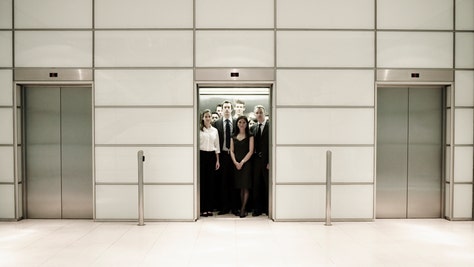 006ee9e2-Group of business people inside an office lift