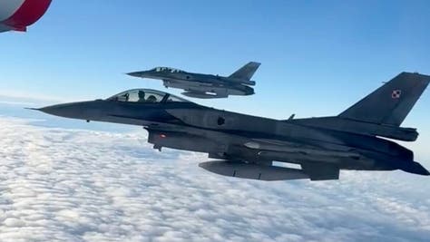Poland's World Cup team gets fighter jet escort out of Polish airspace. The planes were F-16s. (Credit: Screenshot/Twitter Video https://twitter.com/LaczyNasPilka/status/1593252349669085184)