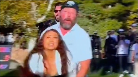 Comedian Bert Kreischer played the hero role during the Netflix Cup. He stopped a woman protesting. Watch a video of the moment. (Credit: Screenshot/X Video https://twitter.com/scaliaiscious/status/1724566294685528270)