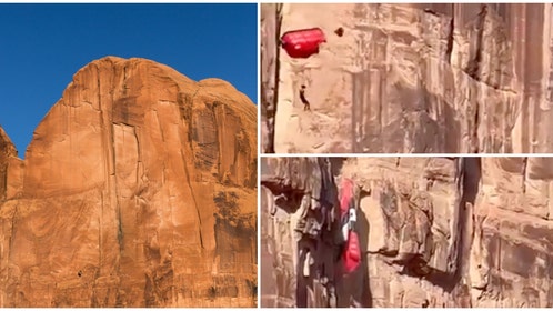 Base Jumper hanging from parachute