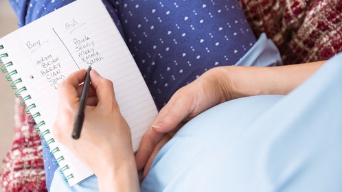 Pregnant woman listing baby names