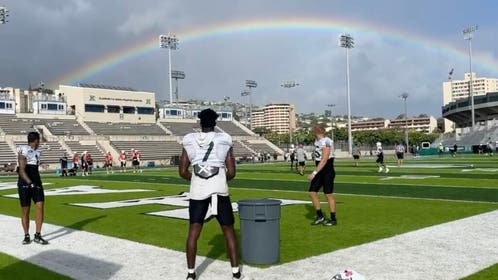 The Hawaii Rainbow Warriors practice under an actual rainbow in awesome video. (Credit: Screenshot/Twitter Video https://twitter.com/c_shimabuku/status/1558650541353275392)