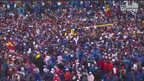 Kansas fans celebrate the win over Oklahoma by carrying to goal posts out of the stadium