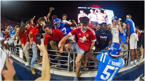 The SEC fined Ole Miss $100,000 for fans rushing the field after the Rebels beat LSU 55-49. A young woman was crushed by security. (Credit: Getty Images)