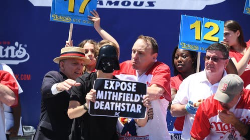 Two protestors interrupt the Nathan's Famous International Hot Dog Eating Contest