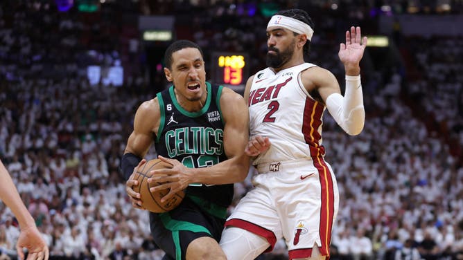 Celtics G Malcolm Brogdon drives to the paint on Heat PG Gabe Vincent during Game 3 of the Eastern Conference Finals in Miami.