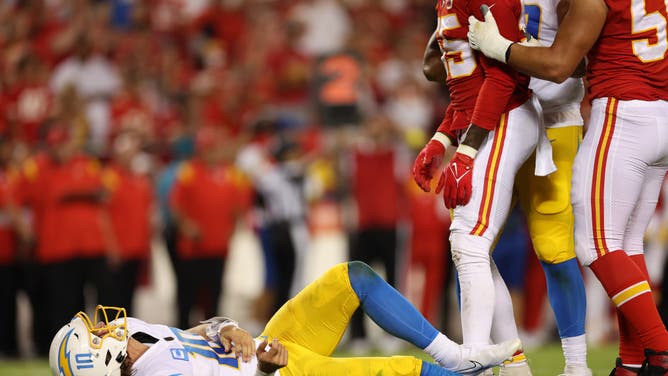 Los Angeles Chargers QB Justin Herbert lays on the ground after being hit by the Chiefs at Arrowhead Stadium in Kansas City, Missouri.