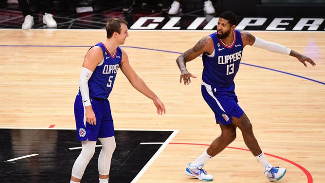 LA Clippers SF Paul George high-fives teammate SG Luke Kennard against the Boston Celtics at Crypto.Com Arena in Los Angeles.