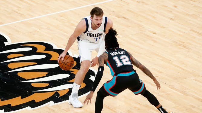 Dallas Mavericks PG Luka Doncic sizing up Memphis Grizzlies PG Ja Morant #12 for a drive to the hoop at FedExForum in Memphis, Tennessee. (Chris Elise/NBAE via Getty Images)
