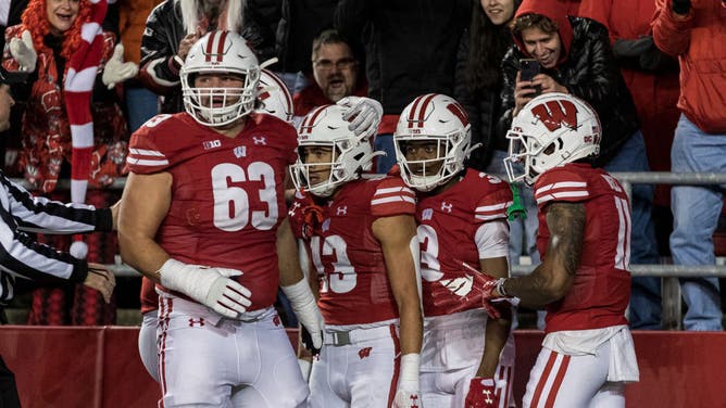 The Wisconsin Badgers celebrate a big play on offensive against the Minnesota Golden Gophers at Barry Alvarez field at Camp Randall Stadium in Madison, Wisconsin.