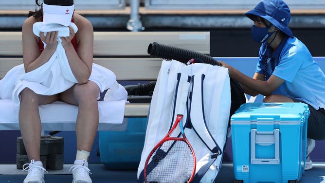 Nao Hibino of Team Japan attempts to cool down between games during her Women's Singles First Round match against Nina Stojanovic of Team Serbia on day one of the Tokyo 2020 Olympic Games at Ariake Tennis Park in Tokyo, on July 24