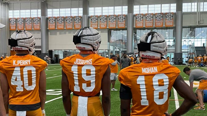 Kalib Perry, Joshua Josephs and William Mohan stand on the sideline during fall camp at Tennessee