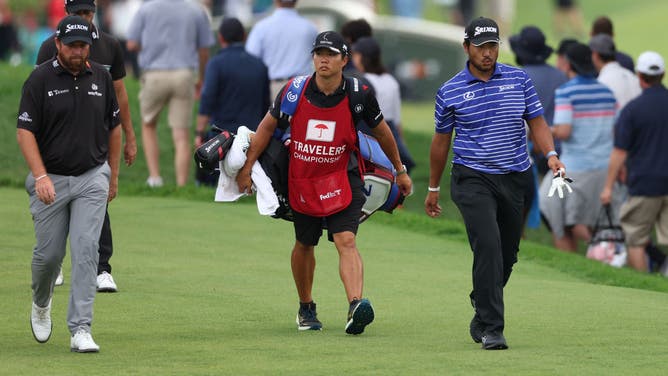 Shane Lowry and Matsuyama walk up a fairway during the Travelers Championship 2023 at TPC River Highlands in Connecticut.