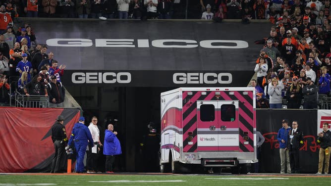 Fans look on as the ambulance leaves carrying Damar Hamlin of the Buffalo Bills after he collapsed after making a tackle against the Cincinnati Bengals.