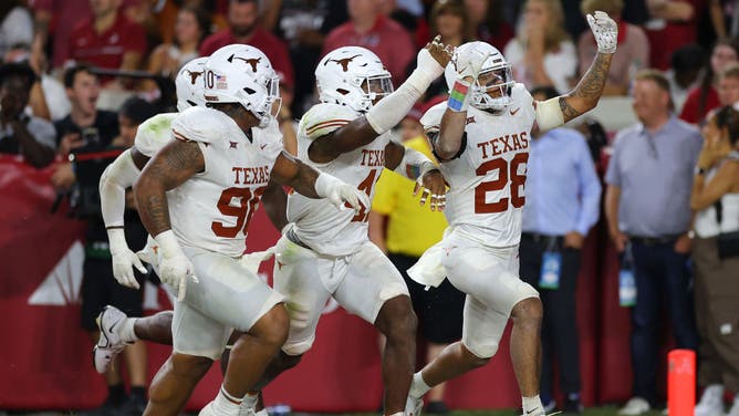 Texas players celebrate the defensive dominance, with five sacks on Saturday night.